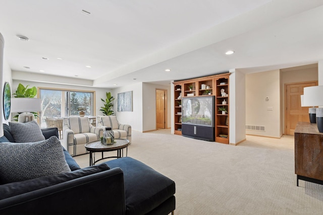 living area featuring baseboards, recessed lighting, visible vents, and light carpet