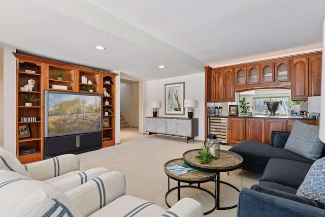 living area with stairs, wine cooler, recessed lighting, and light colored carpet