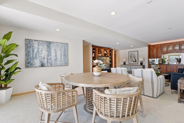 dining space featuring recessed lighting, light colored carpet, and baseboards