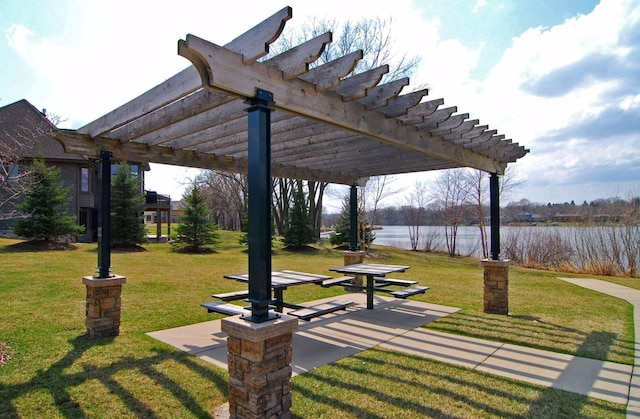 view of property's community with a yard, a water view, and a pergola