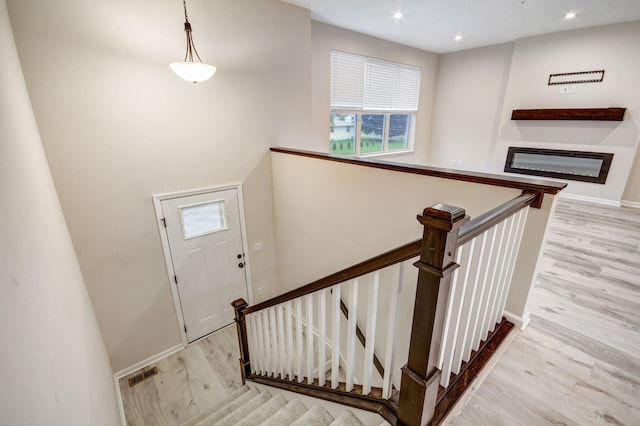 staircase with hardwood / wood-style flooring