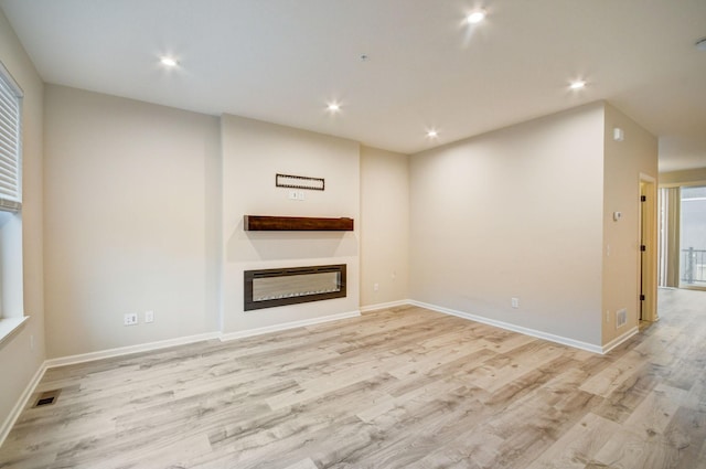 unfurnished living room with light hardwood / wood-style floors