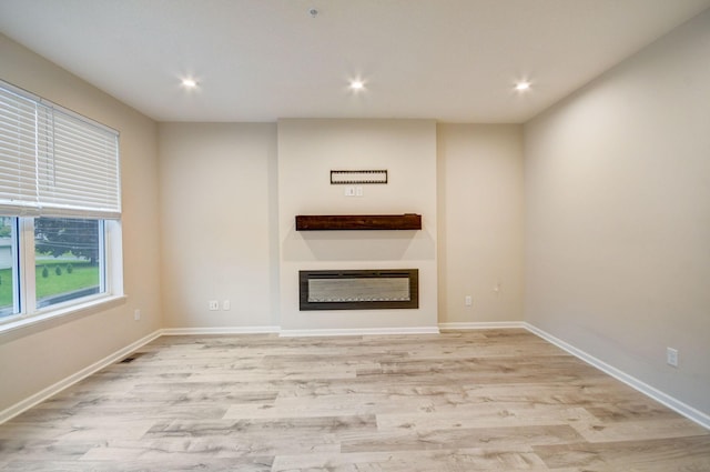 unfurnished living room with light hardwood / wood-style flooring