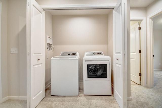 laundry area featuring light colored carpet and independent washer and dryer