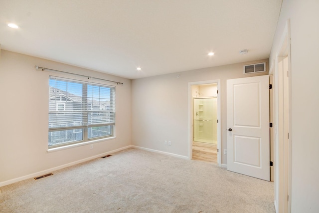 unfurnished room with light carpet