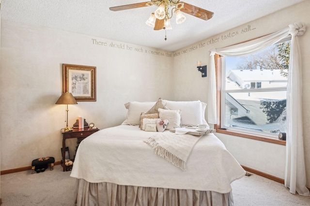 bedroom with a textured ceiling, light carpet, and ceiling fan