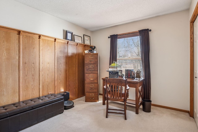 office area featuring a textured ceiling and light carpet