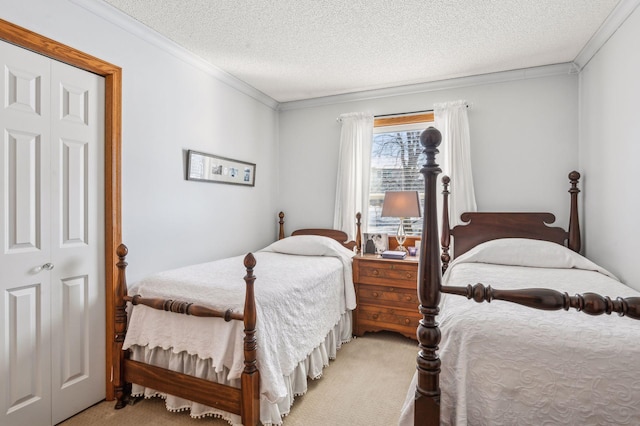 carpeted bedroom with a textured ceiling and ornamental molding