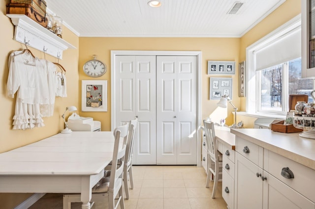 interior space with ornamental molding and a closet