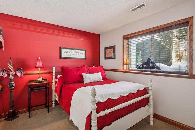 bedroom featuring carpet flooring and a textured ceiling