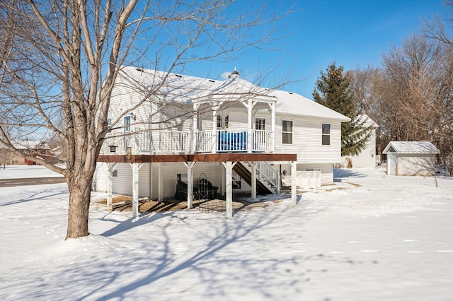 view of front of property with a storage shed and a wooden deck