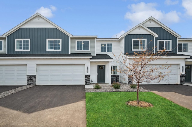 view of front of property with central AC, a garage, and a front yard