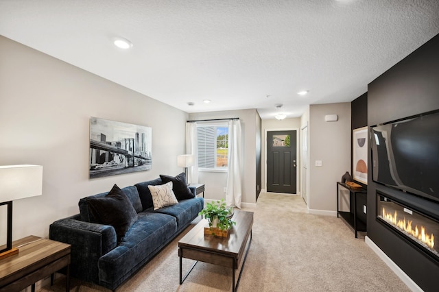 carpeted living room featuring a textured ceiling