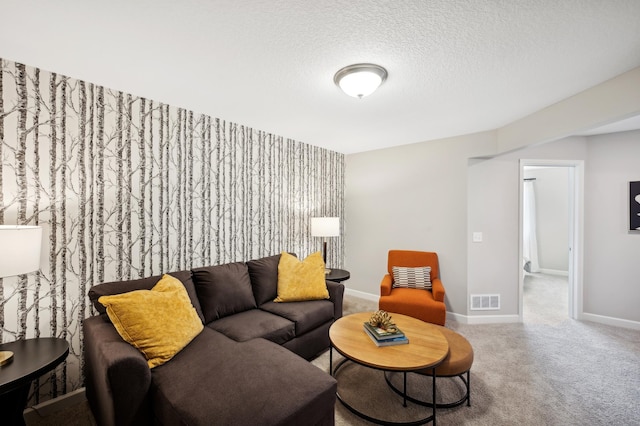 living room featuring carpet flooring and a textured ceiling