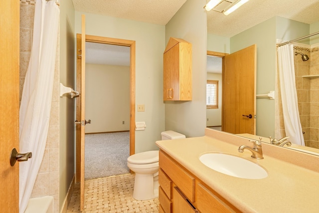 bathroom with vanity, curtained shower, toilet, and a textured ceiling