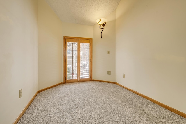 spare room with carpet and a textured ceiling