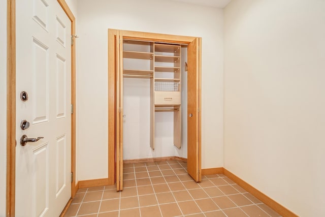 hallway featuring tile patterned flooring