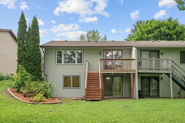 1541 2nd Ave SE, Cambridge, MN 55008 - rear view of house featuring stairway, a wooden deck, and a lawn