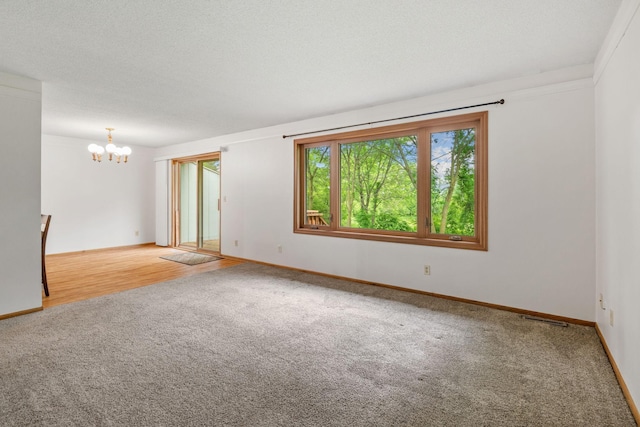 1541 2nd Ave SE, Cambridge, MN 55008 - spare room featuring carpet flooring and a chandelier