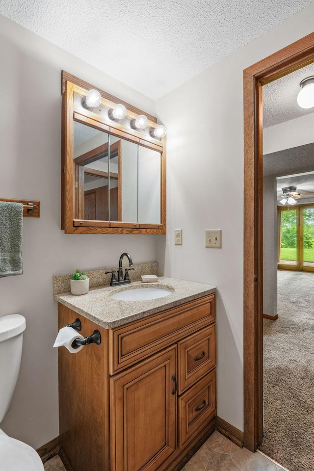 1541 2nd Ave SE, Cambridge, MN 55008 - half bath featuring vanity, a textured ceiling, and ceiling fan