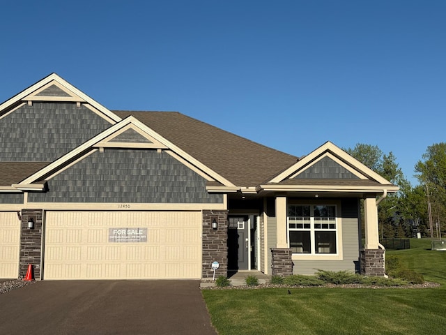 12450 Waterside Ct, Rogers, MN 55374 - craftsman-style home with an attached garage, a front yard, asphalt driveway, and a shingled roof