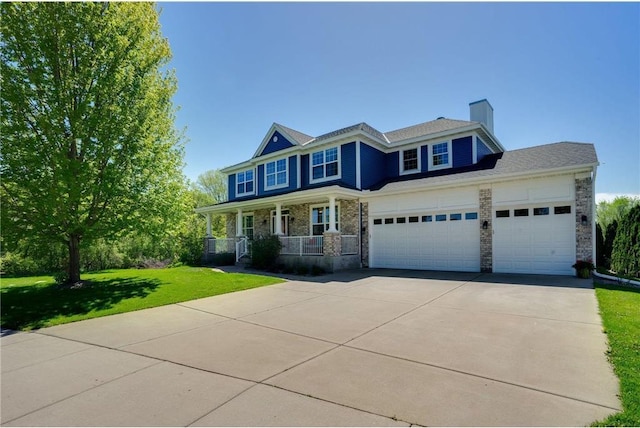 view of front of property with a porch, an attached garage, a front lawn, and concrete driveway