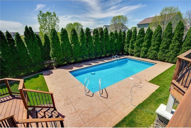 view of swimming pool with a fenced in pool, a wooden deck, a yard, a fenced backyard, and a patio area