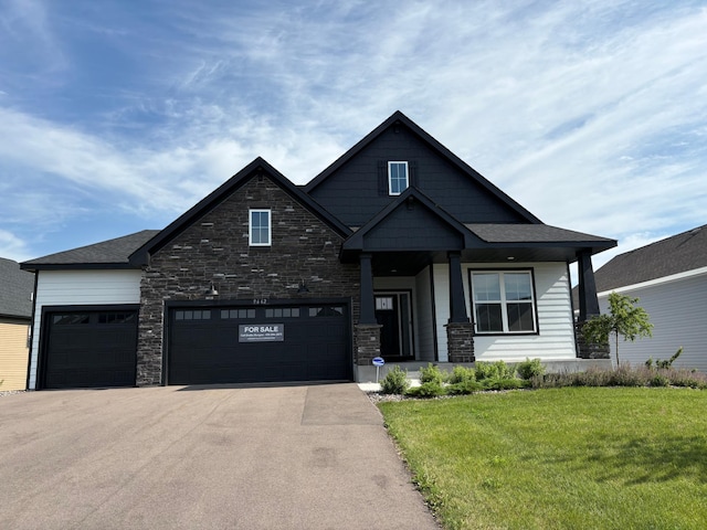 9662 49th St NE, Saint Michael, MN 55376 - view of front of property with a front lawn, driveway, stone siding, and a garage