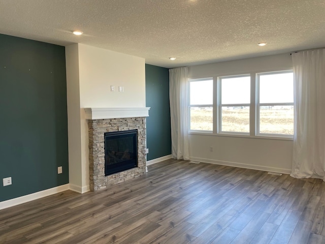 9662 49th St NE, Saint Michael, MN 55376 - unfurnished living room with a textured ceiling, dark wood finished floors, a fireplace, and recessed lighting
