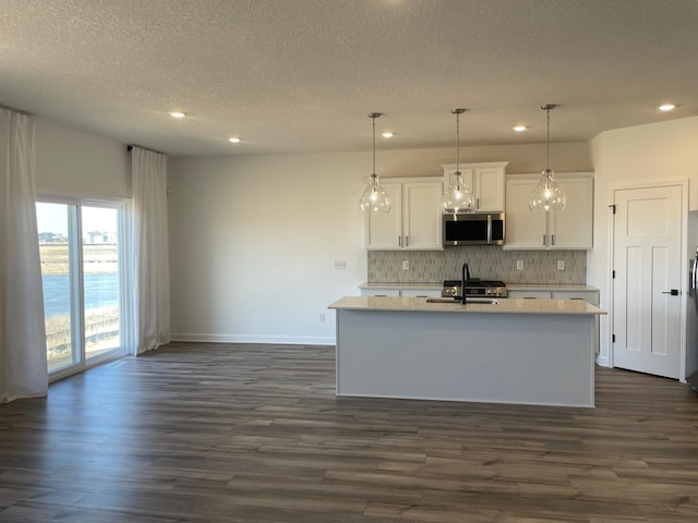 9662 49th St NE, Saint Michael, MN 55376 - kitchen with stainless steel microwave, recessed lighting, decorative backsplash, dark wood finished floors, and light countertops