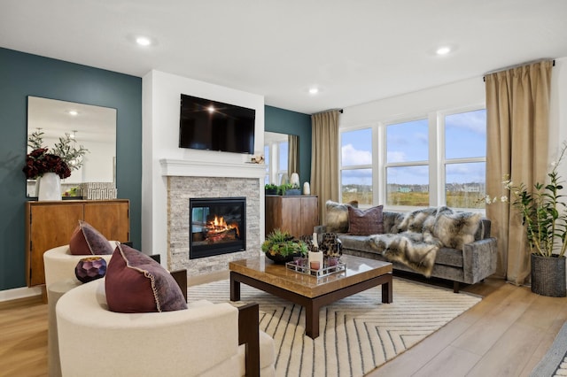 9662 49th St NE, Saint Michael, MN 55376 - living room with a stone fireplace, light wood-style floors, and recessed lighting