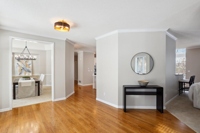 hall featuring hardwood / wood-style floors, a notable chandelier, and ornamental molding