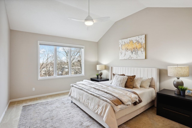 carpeted bedroom with ceiling fan and vaulted ceiling