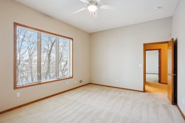 carpeted empty room featuring ceiling fan