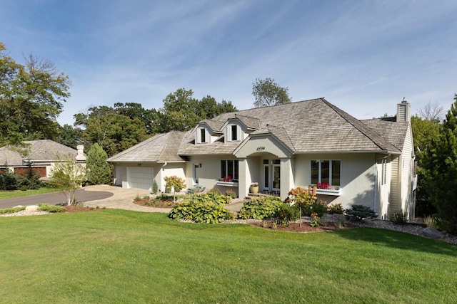 view of front of property featuring a garage and a front yard