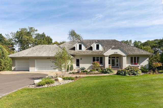 view of front facade with a garage and a front lawn