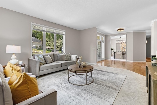 6229 Morningside Cir, Eden Prairie, MN 55344 - living area featuring a chandelier, wood finished floors, and ornamental molding