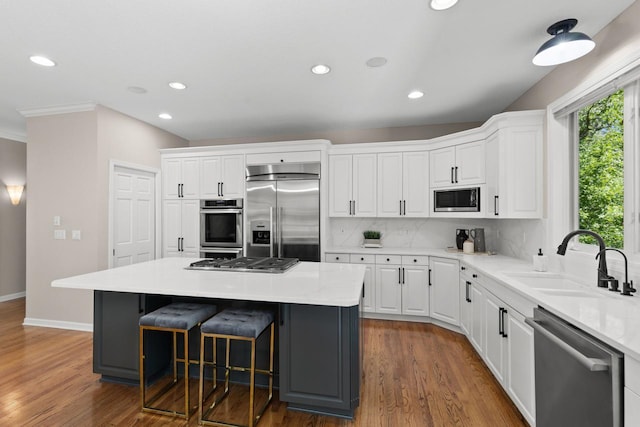6229 Morningside Cir, Eden Prairie, MN 55344 - kitchen featuring built in appliances, white cabinets, a center island, dark wood-style floors, and recessed lighting