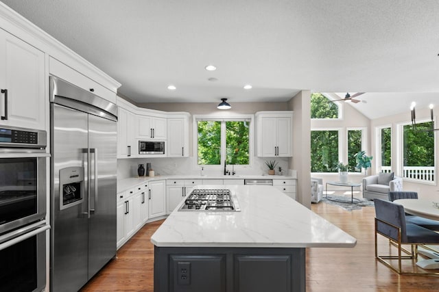6229 Morningside Cir, Eden Prairie, MN 55344 - kitchen featuring built in appliances, white cabinetry, a kitchen island, and recessed lighting