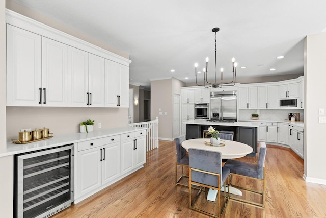 6229 Morningside Cir, Eden Prairie, MN 55344 - dining room featuring beverage cooler, recessed lighting, a chandelier, and light wood-style floors