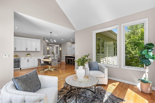 6229 Morningside Cir, Eden Prairie, MN 55344 - living room featuring light wood finished floors, a chandelier, vaulted ceiling, wine cooler, and recessed lighting