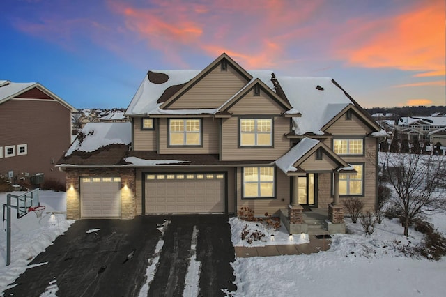 view of front of home featuring an attached garage and aphalt driveway