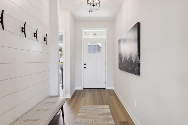 doorway to outside featuring light wood-style flooring and baseboards