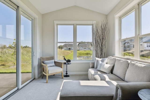 sunroom with a residential view and vaulted ceiling