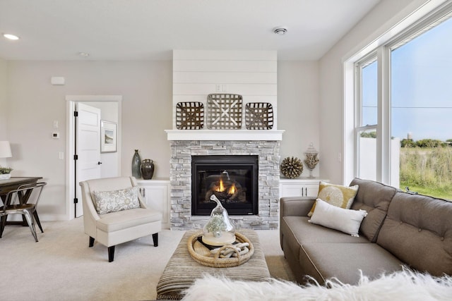 living room with light carpet, a fireplace, and baseboards