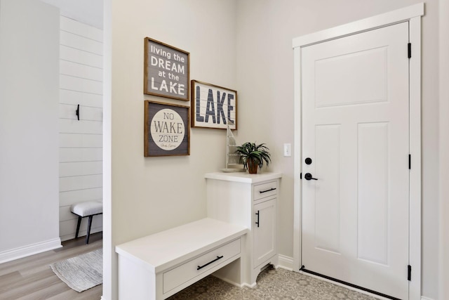 mudroom with baseboards and light wood-style floors