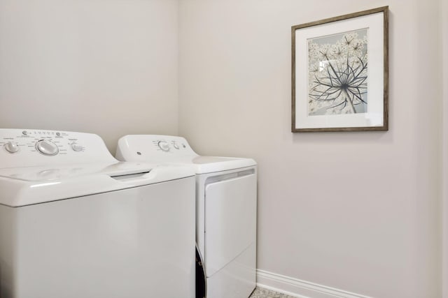 laundry area with laundry area, baseboards, and separate washer and dryer