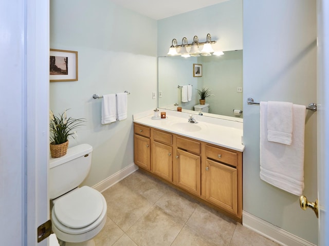 bathroom featuring vanity, tile patterned flooring, and toilet