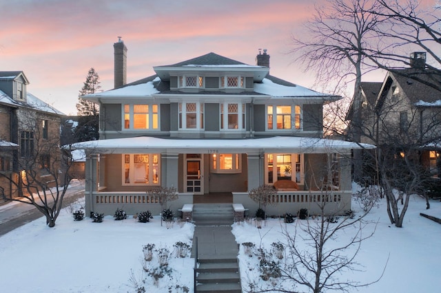 view of front of home featuring a porch and a chimney