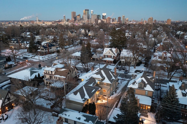 snowy aerial view with a city view